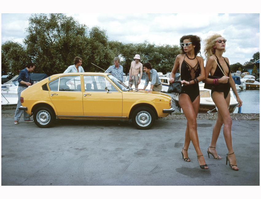 two-young-women-in-swimsuits-fail-to-catch-the-eyes-of-a-group-of-men-who-are-admiring-an-alfa-romeo-car-august-1979-brian-duffy